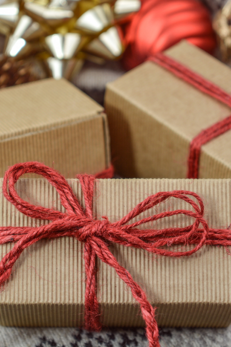 Gifts wrapped in brown paper and tied with red bows.