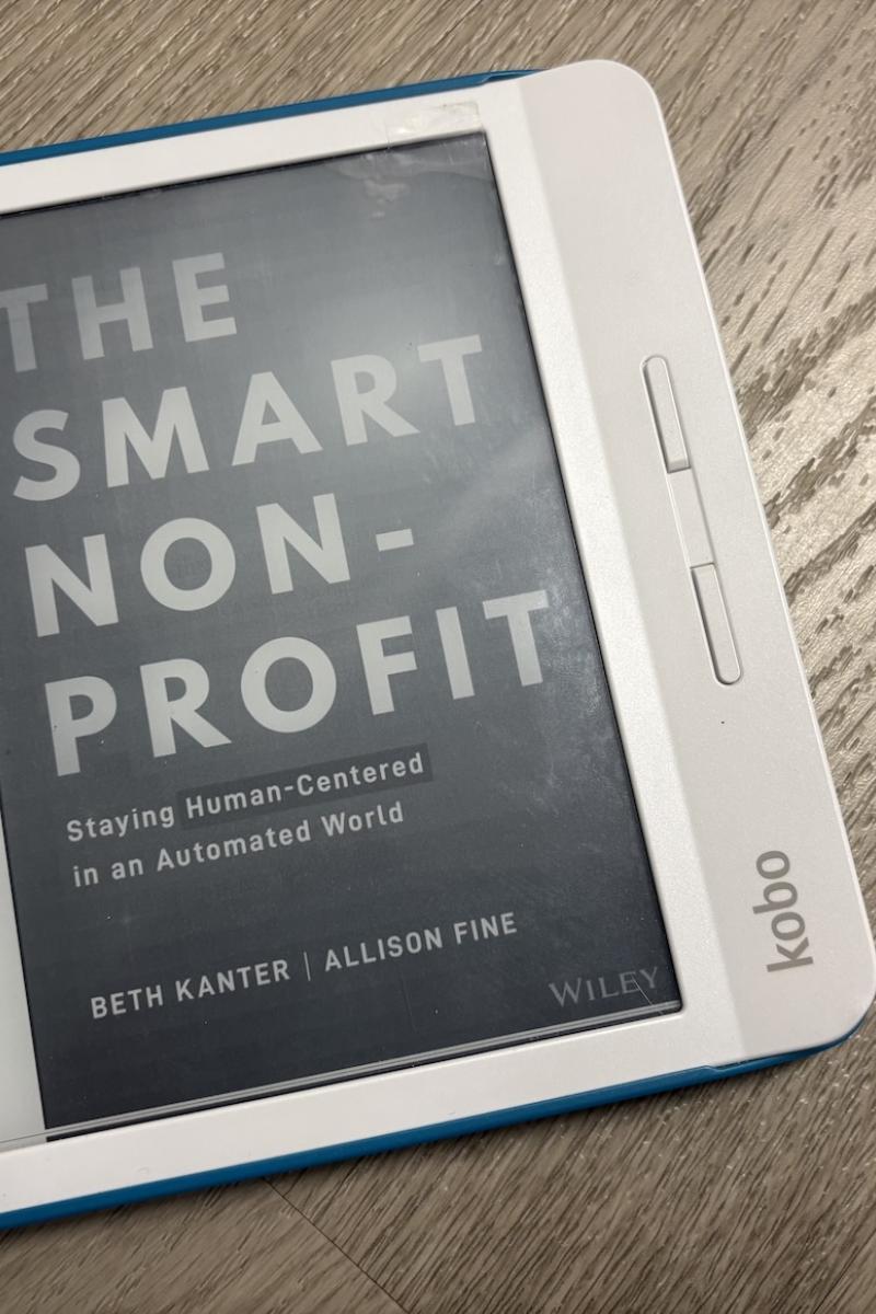 An e-reader displays the cover of the book "The Smart Nonprofit".
